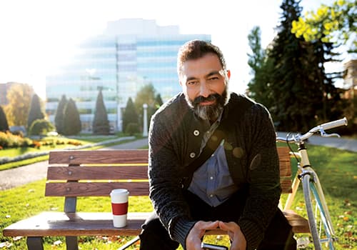 bearded man sitting on the bench