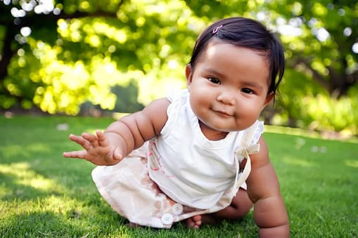 baby crawling on grass